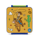 Toy with a cowboy character on a horse, surrounded by desert elements, on a yellow grid background.