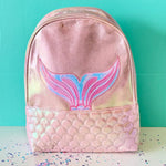 Pink backpack with mermaid tail design on a teal background
